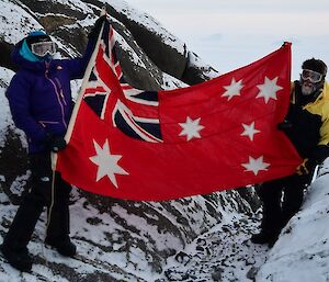 Daleen and Richard raise the historical Australian flag.