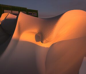 Sunset colours highlighting sculptured snow in our snow dune.