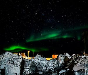 Piles of cleared snow with an aurora.