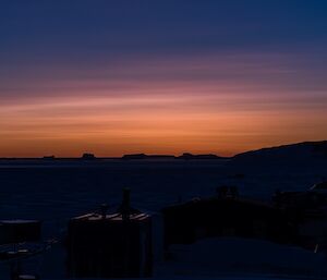 Polar stratospheric cloud at sunset, giving the sky a pretty purple and orange colour.