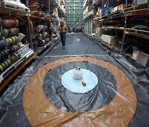 Curling in the Green store. Rhys, official score keeper inspecting Sharky’s stone.