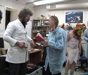 A party scene with a lab theme for the 48hr Film Festival. People are standing around in lab coats and protective clothing.