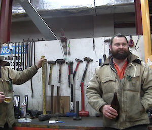 The mechanics, Jock and Marc, showcasing their hammers for the film scene.