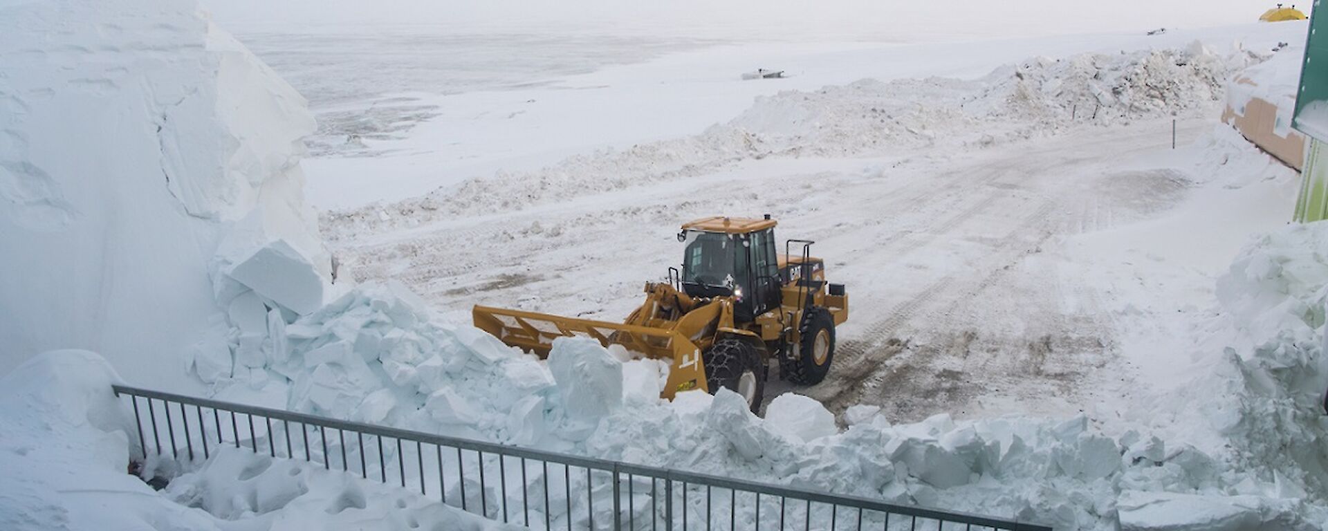 Clearing snow to reclaim the view in front of the living quarters building.