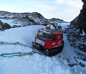 Practicing winching a Hägg up a slope. The red Hägg is about to be driven onto ramps and be winched up.