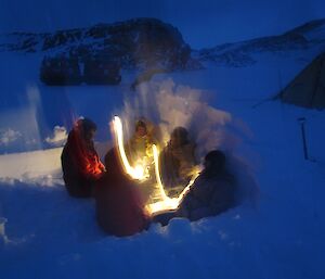 Enjoying time in a snow shelter and out of the wind.