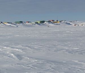 The view of station from the sea ice. The blizz tails extending from the buildings down to the bay.