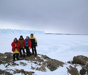 Ralph, Richard, Kirsten and Rob at a lookout with the glacier tongue and local polynya (area of open water) visible behind them.
