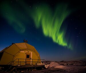 Aurora over a building that looks a little like a pineapple.