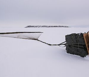 A pallet with its parachute deflated, awaiting delivery to station.