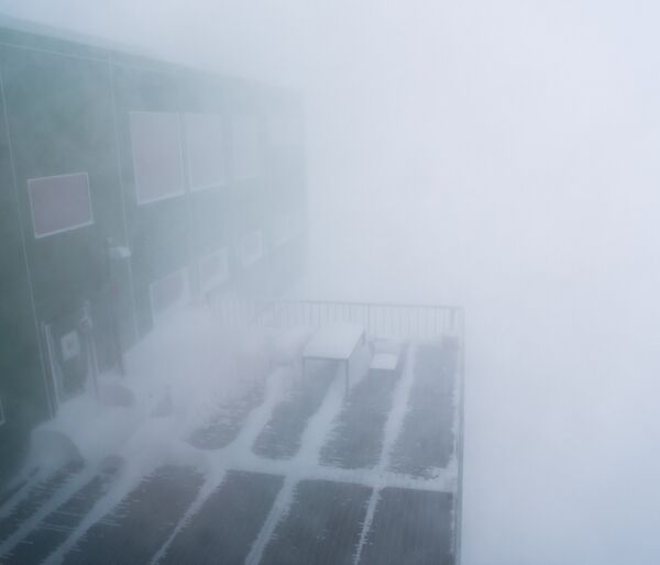 A building in a blizzard, very limited vision.