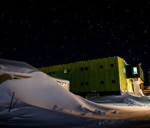 Buildings lit up by the moonlight with nearby blizz tails.