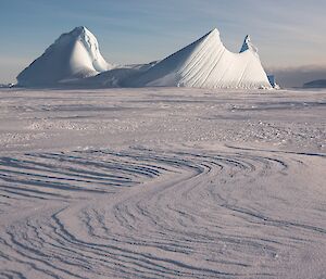 With the reappearance of the sun, the patterns in the windblown snow are visible.