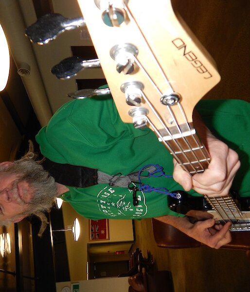 A man playing a bass guitar.