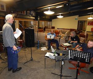 A group of expeditioners with their instruments completing a sound check.