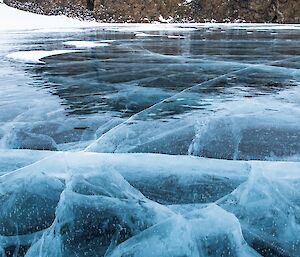 The beautiful lake ice at Lichen Lake.The ice is as clear as glass with deep cracks through it.