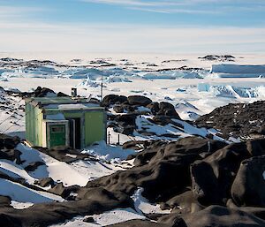 Bandits hut looking very picturesque perched up on a hill with icebergs all around it.