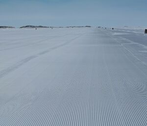 The finished runway, marked out with flags and ready to receive a plane.