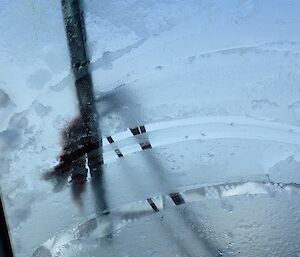 The weather takes a turn. Ice covers the windscreen as the wiper battles to clear the view.