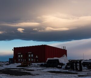 Dark, moody clouds over the red Emergency Vehicle Shed.