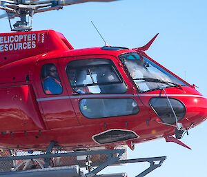 People in a red helicopter.