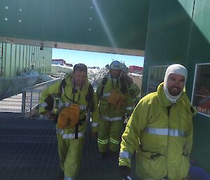 Fire team members walk back to a building after a drill.
