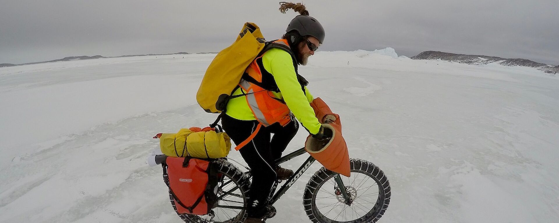 A cyclist rides on the ice.