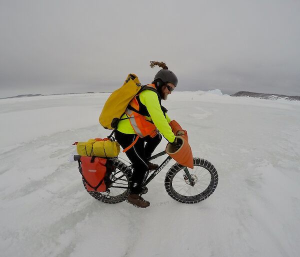 A cyclist rides on the ice.