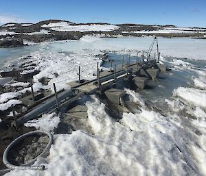 A frozen tarn with equipment in it.