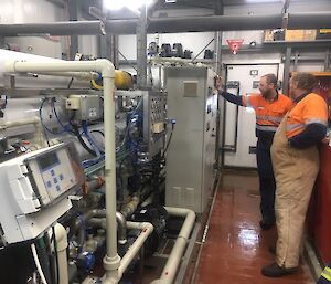 Two men working in a plant room.