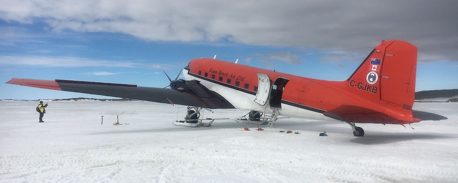 A twin engine skiplane on the ice.