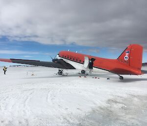 A twin engine skiplane on the ice.