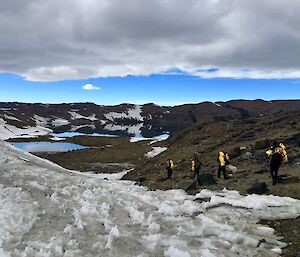 A group walks through the hills.