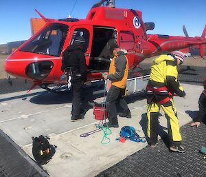 A group prepares to board a helicopter