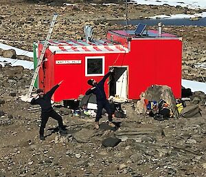 A newly painted red field hut.