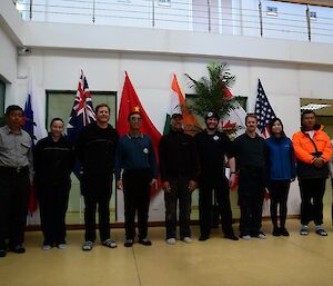 A group in front of the Chines and Australian flags