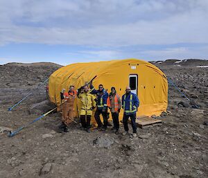 A group in front of a tent