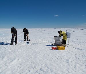 A team working on equipment on the ice