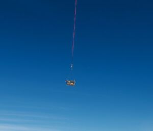 A helicopter sling loading cargo