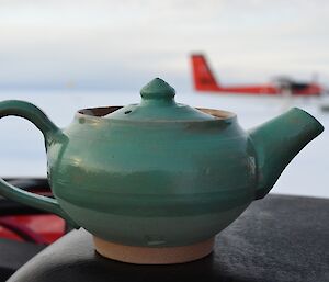 A green ceramic teapot