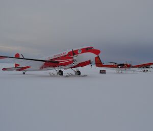 3 planes lined up on the snow
