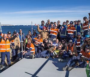 The end of season trades team photo taken on top of the scaffolding all dressed in their high vis work wear.