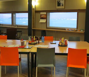 Looking over the dining tables through the windows to the ice bergs in the bay.