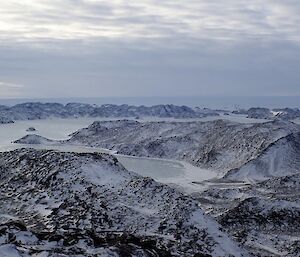 Looking from the top of Lied Bluff over the Vestfold lightly snow covered rocky valleys and fjords.