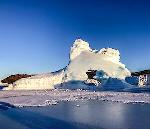 The sun glowing on a landlocked ice berg.