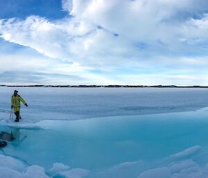 shallow moat of blue water between the island and formed in the sea ice at the tide line.