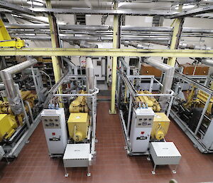 Looking down along the four yellow power generators in the Main Power House.