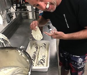 Graham helping make chocolate ripple cake and managing to get cream everywhere, even on his face.