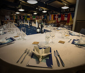 The evening dinner table set with different country flags hanging on the back walls.