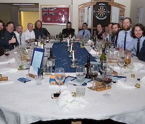 All 19 expeditioners sitting at the mid winters dinner table.